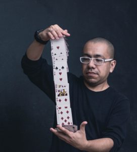 Man shuffling a deck of cards. 